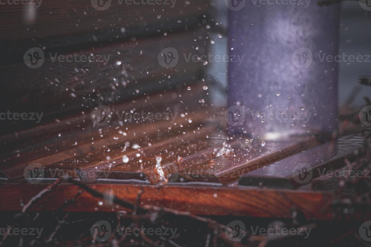 Close-up of drops falling on a wooden background in an urban graduation tower photo