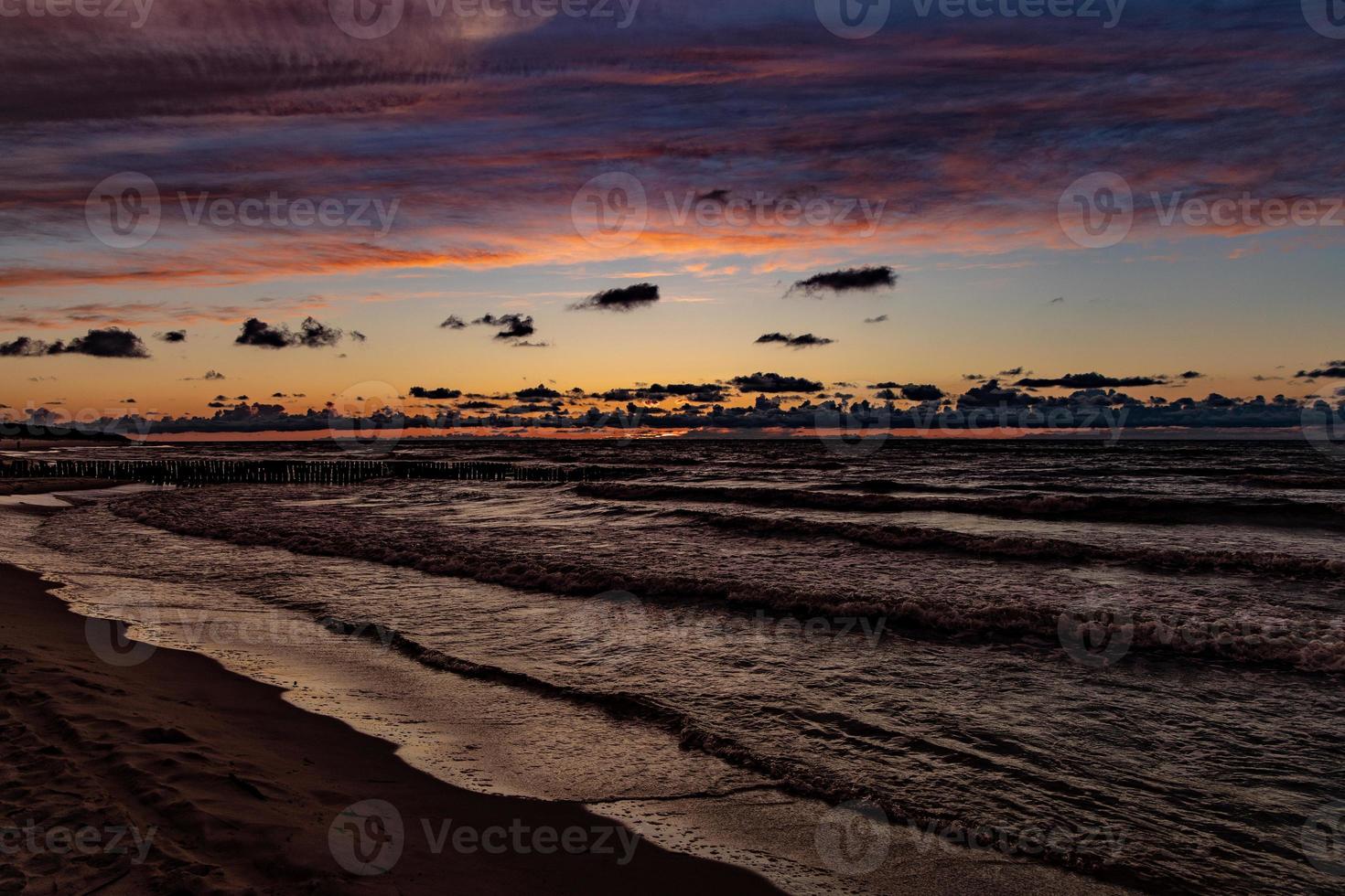 picturesque calm sunset with colorful clouds on the shores of the Baltic Sea in Poland photo