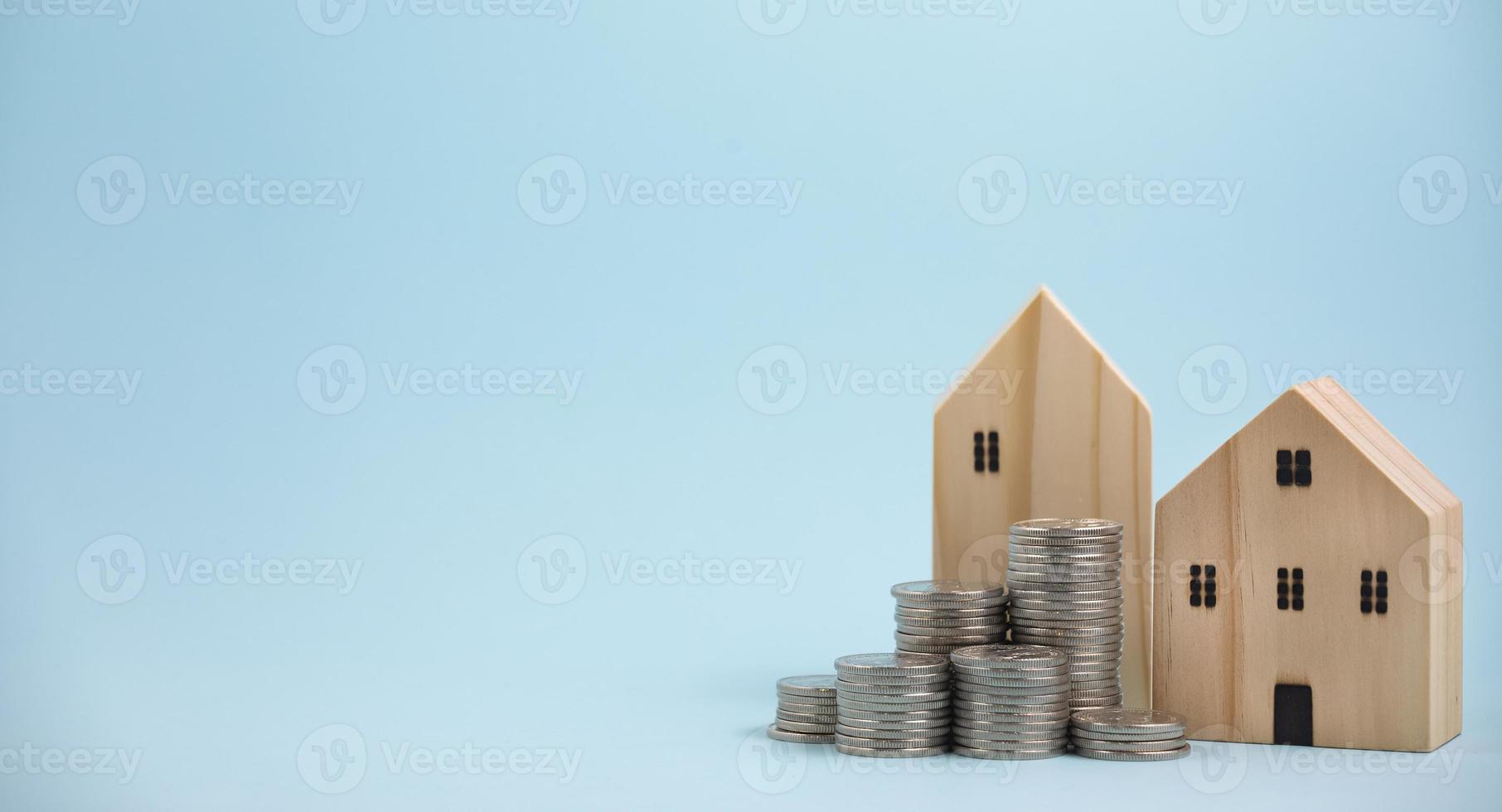 Coins stack in front of wooden home on wooden table, Save money concept, Property investment, house loan, reverse mortgage, gold coins money stack growth, saving money coins stack future for home photo
