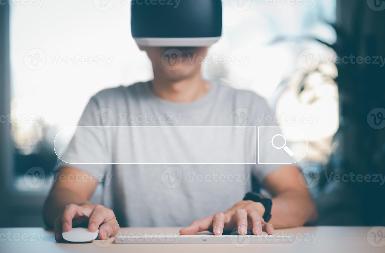 Man wearing VR glasses virtual touch keyboard and Searching Browsing Internet Data Information with the blank search bar. man's hands are using a computer keyboard to Searching for information. photo