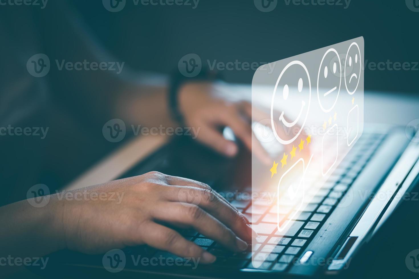 Businessman using laptop computer to input point and evaluation result on company website, Customer service satisfaction survey, satisfaction through the application on tablet screen, rating 5 stars. photo