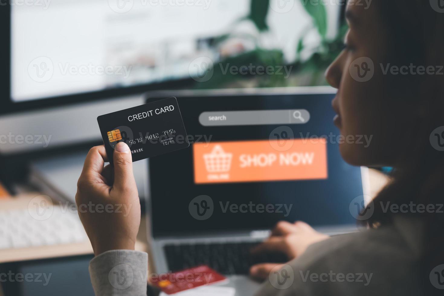 Model credit card and using laptop. woman hold visa card and  working from home. Online shopping, e-commerce, internet banking, spending money, work from home concept. Internet online banking photo