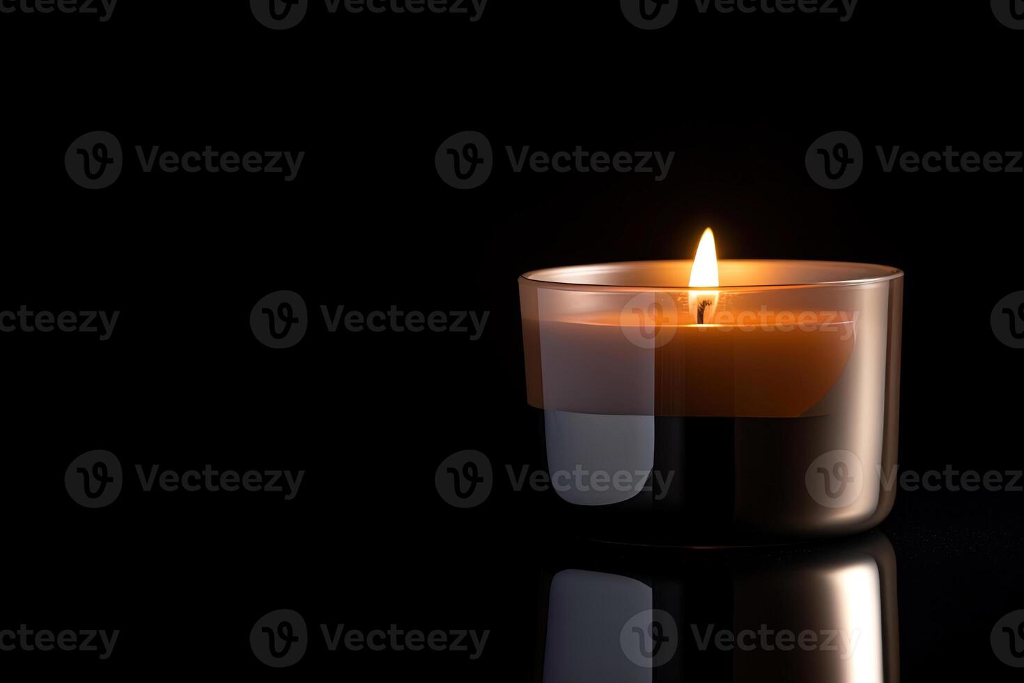 a candle is lit in the dark conveying memorial death and hope with copy space. photo