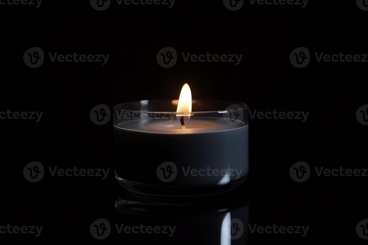 a candle is lit in the dark conveying memorial death and hope. photo