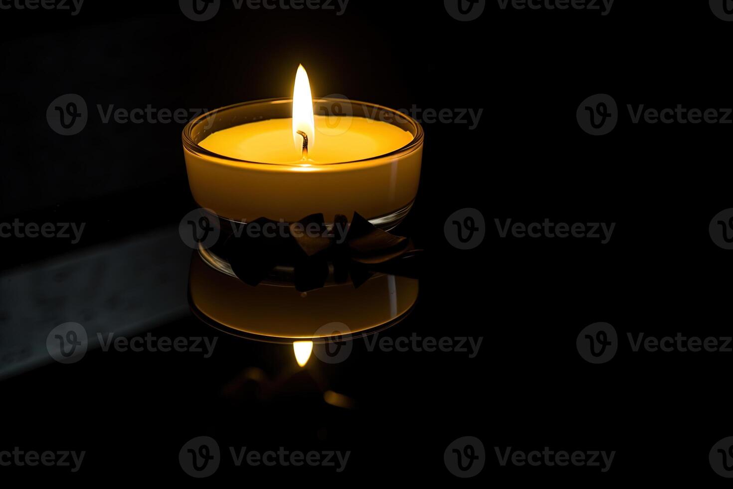 a candle is lit in the dark conveying memorial death and hope with copy space. photo