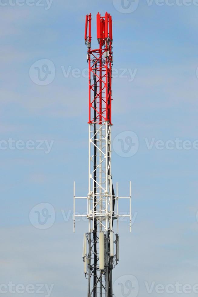 Red and White Telecommunication Mast with Antennas photo