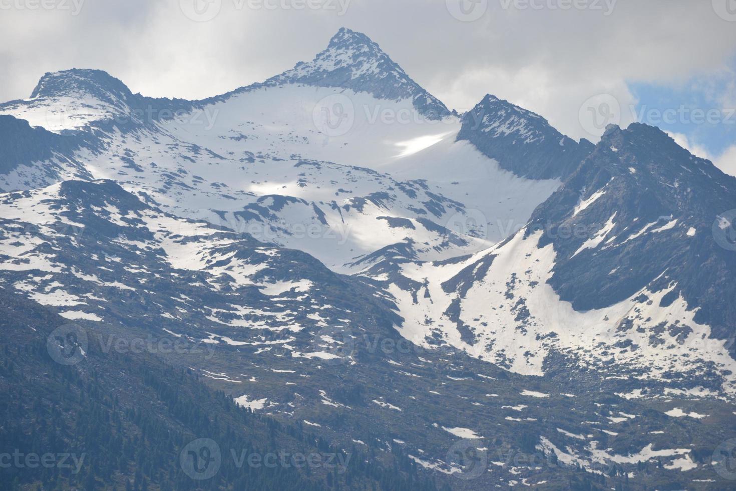 Rocky Peak of the Mountain Covered with Snow - Alps in Austria photo