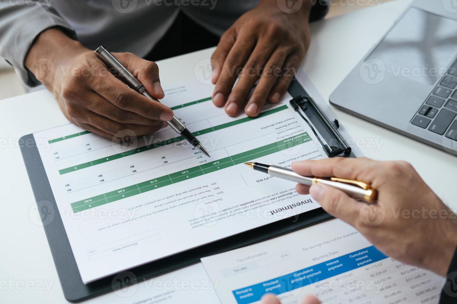 Close up view of investment consultant giving money management plan and advice to his client during th meeting time. photo