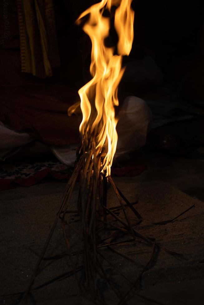 Huge bonfire close-up on a dark background. Campfire with flame at nighttime. Beautiful orange flame on burning wood. Campfire burning with huge flame close-up photo. Beautiful burning bonfire. photo