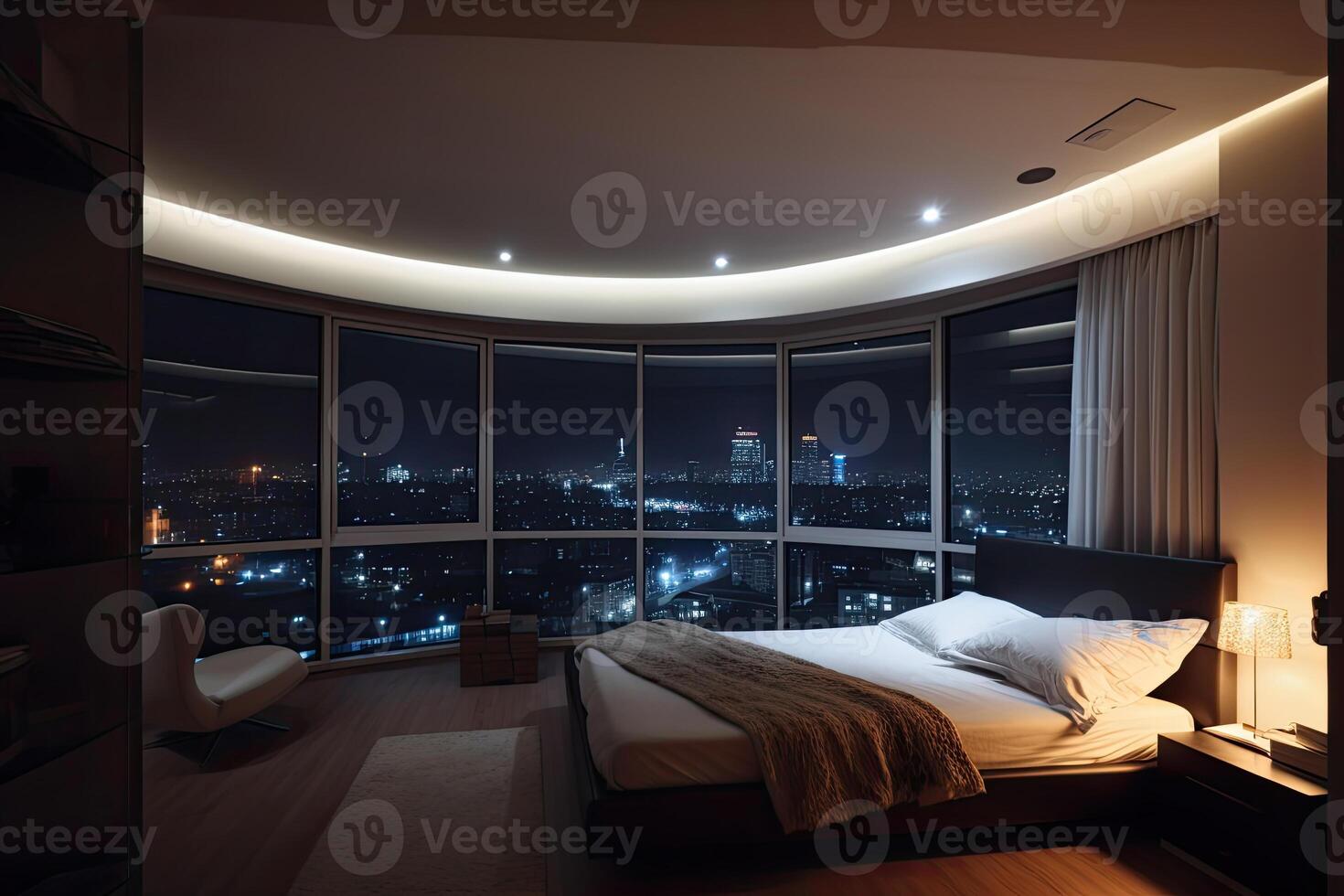 Large bed in living room with night city view in window. photo