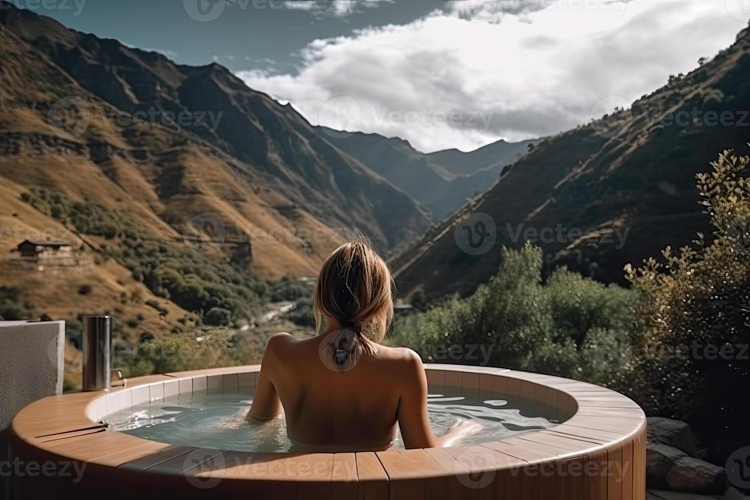 Back view of nacked woman relaxing in jacuzzi outdoors. photo