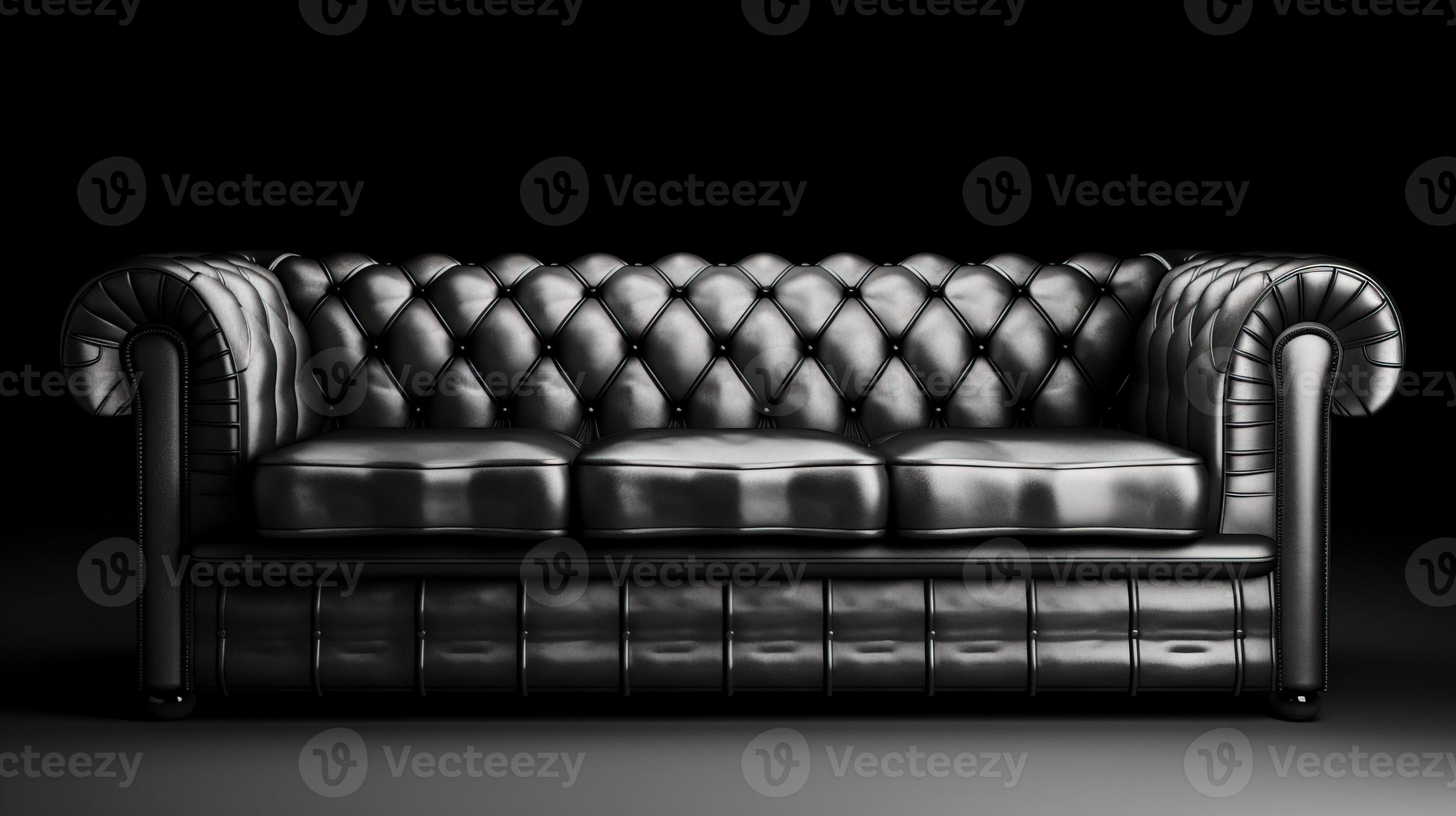 Chesterfield sofa made of black leather on a dark background, isolate