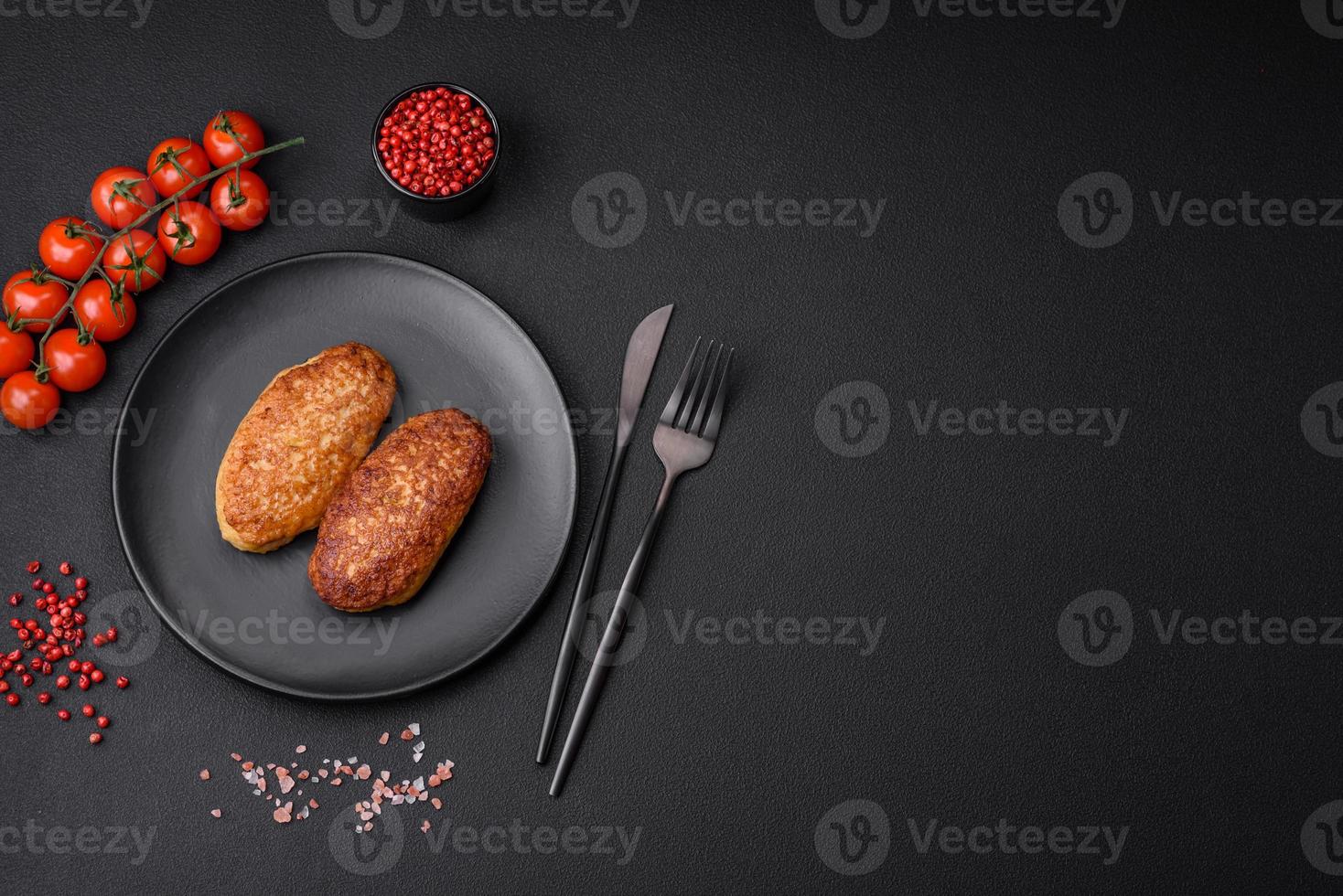 Delicious fried cutlets or meatballs from minced fish with spices and herbs photo