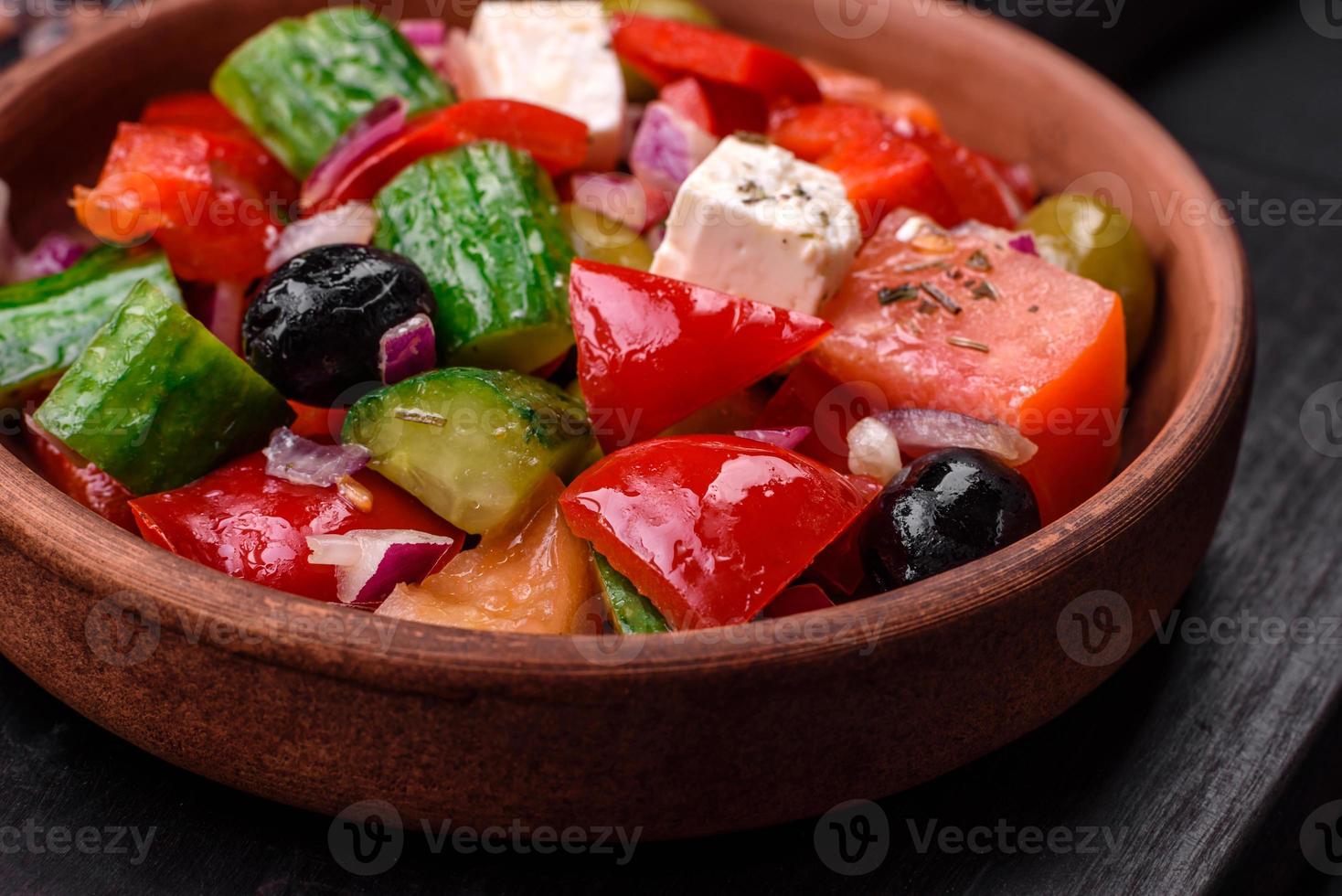 Delicious, fresh Greek salad with feta cheese, olives, tomatoes and cucumbers photo