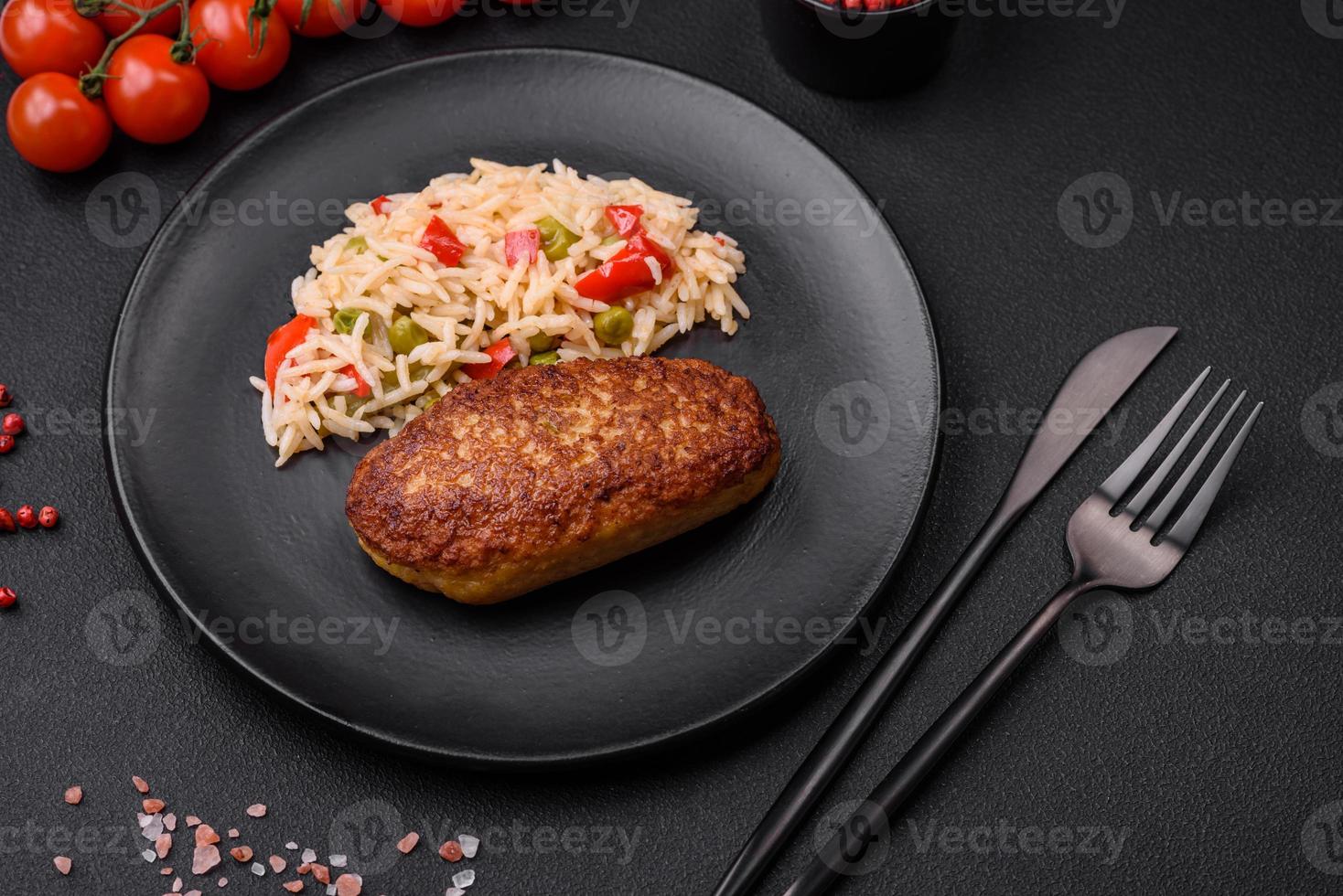 Delicious fried cutlets or meatballs of minced fish with rice photo