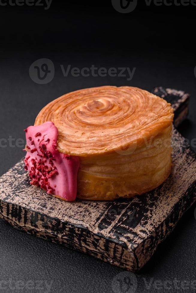 Round puff pastry croissant with raspberry filling or new york roll photo