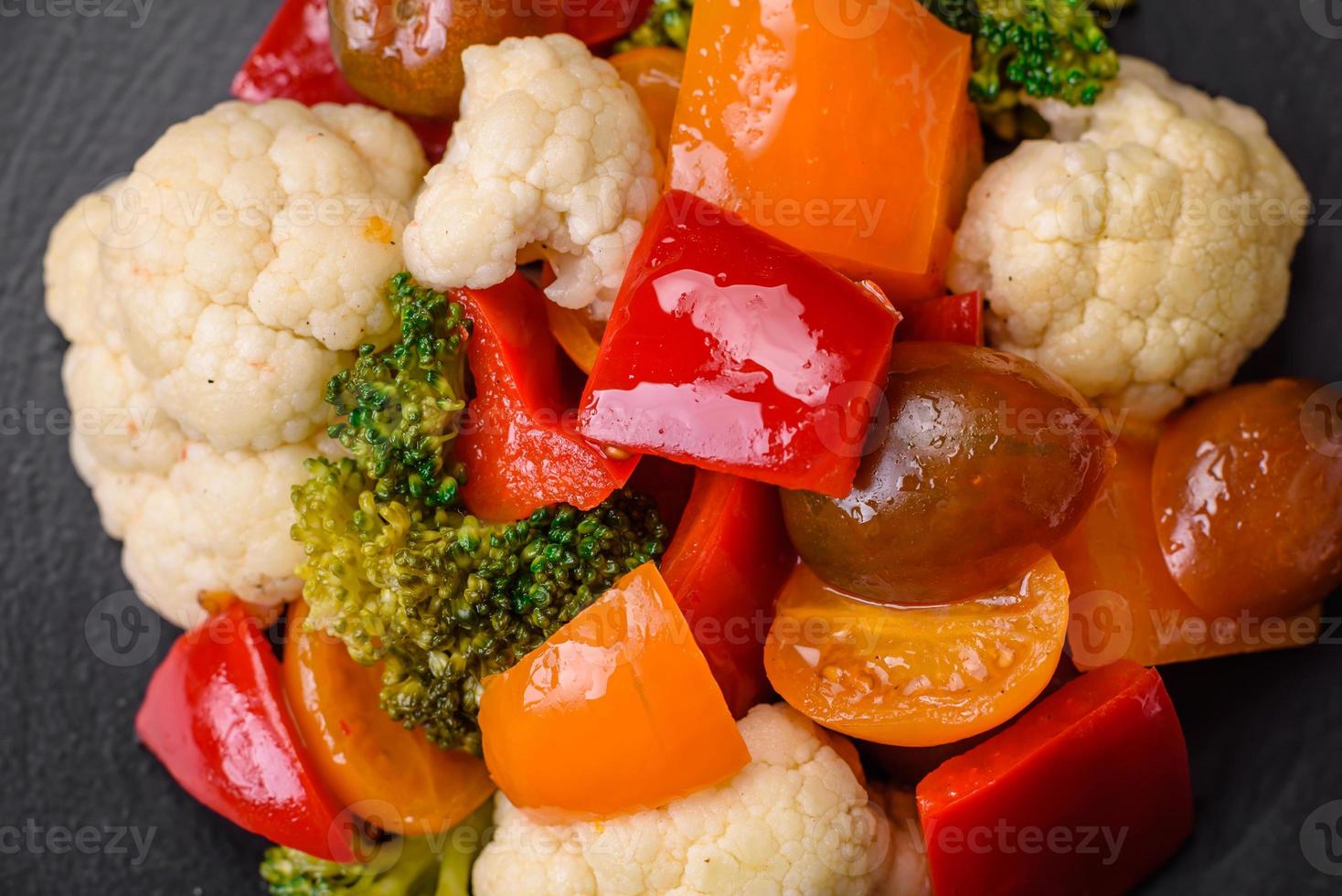 Delicious salad of fresh cherry tomatoes, sweet peppers, broccoli and cauliflower photo