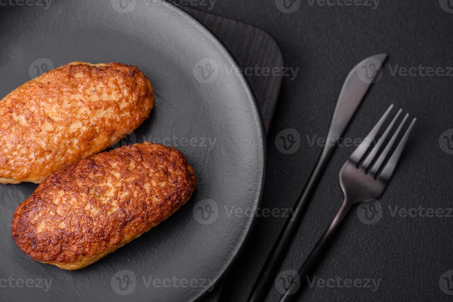 Delicious fried cutlets or meatballs from minced fish with spices and herbs photo