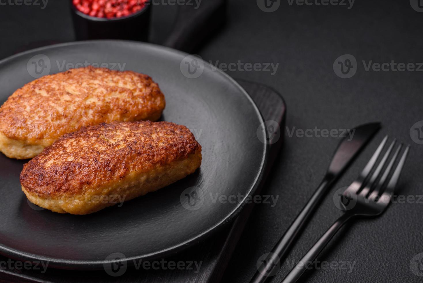 Delicious fried cutlets or meatballs from minced fish with spices and herbs photo