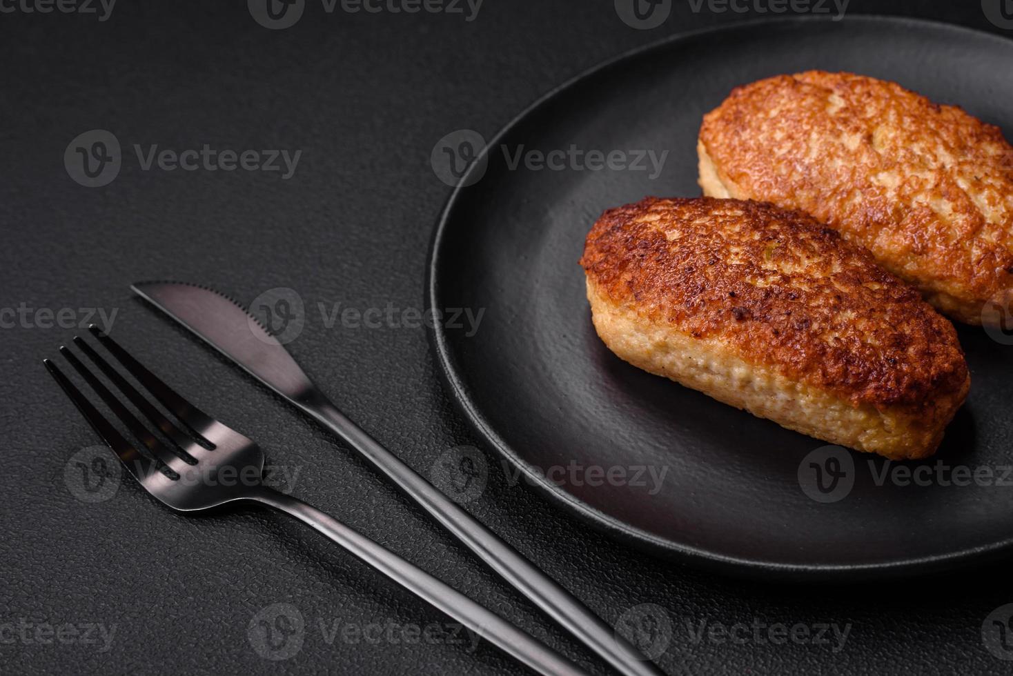 Delicious fried cutlets or meatballs from minced fish with spices and herbs photo