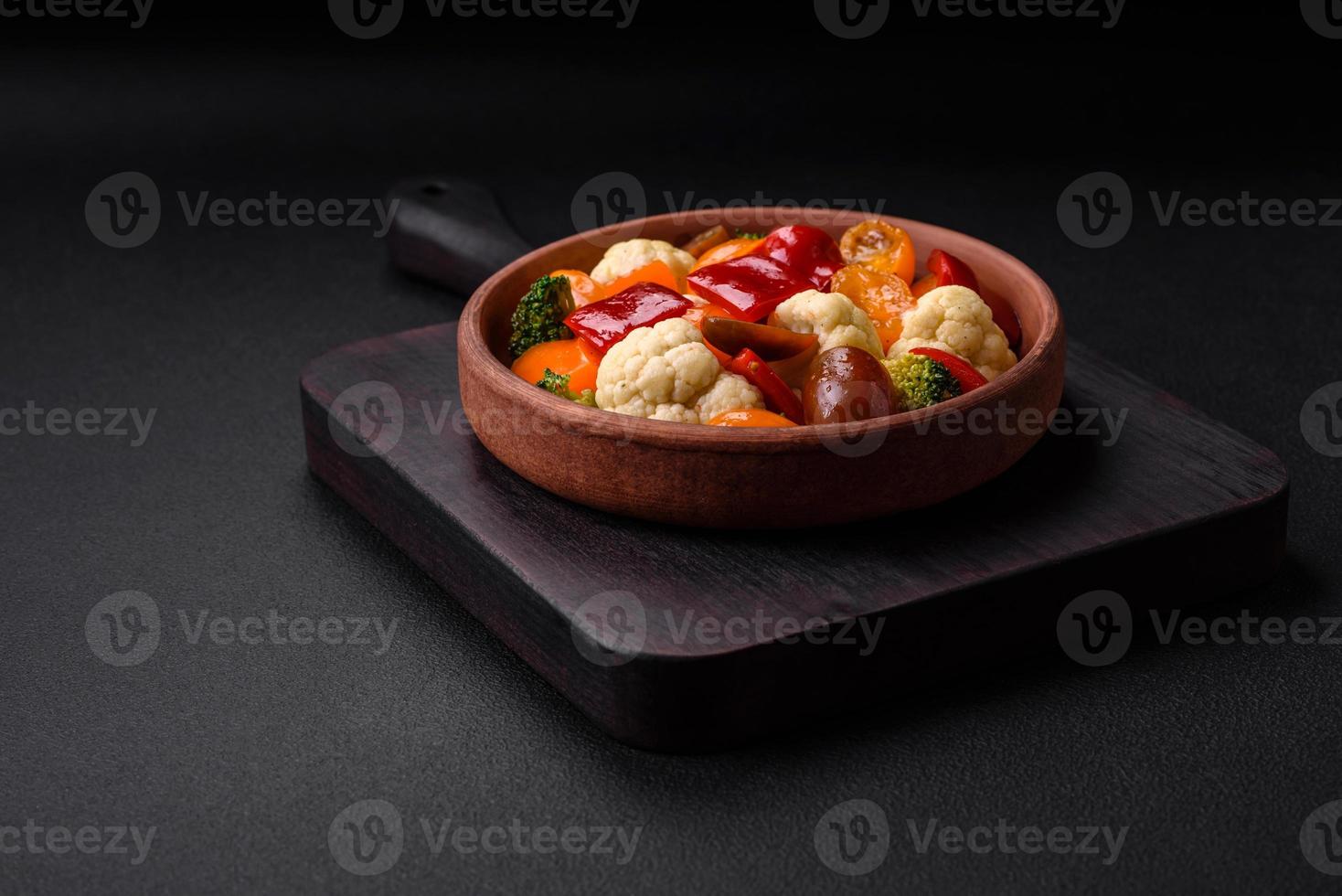Delicious salad of fresh cherry tomatoes, sweet peppers, broccoli and cauliflower photo