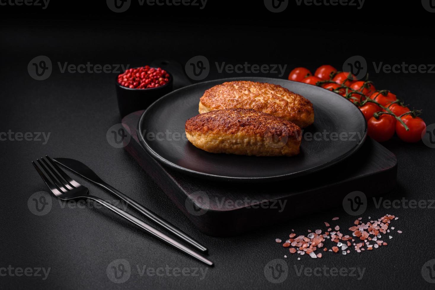 Delicious fried cutlets or meatballs from minced fish with spices and herbs photo