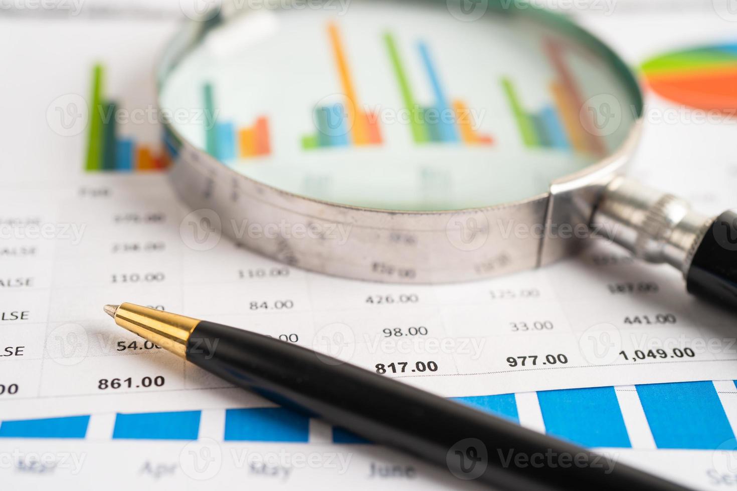Magnifying glass on graph paper. Financial development, Banking Account, Statistics, Investment Analytic research data economy, Business concept. photo