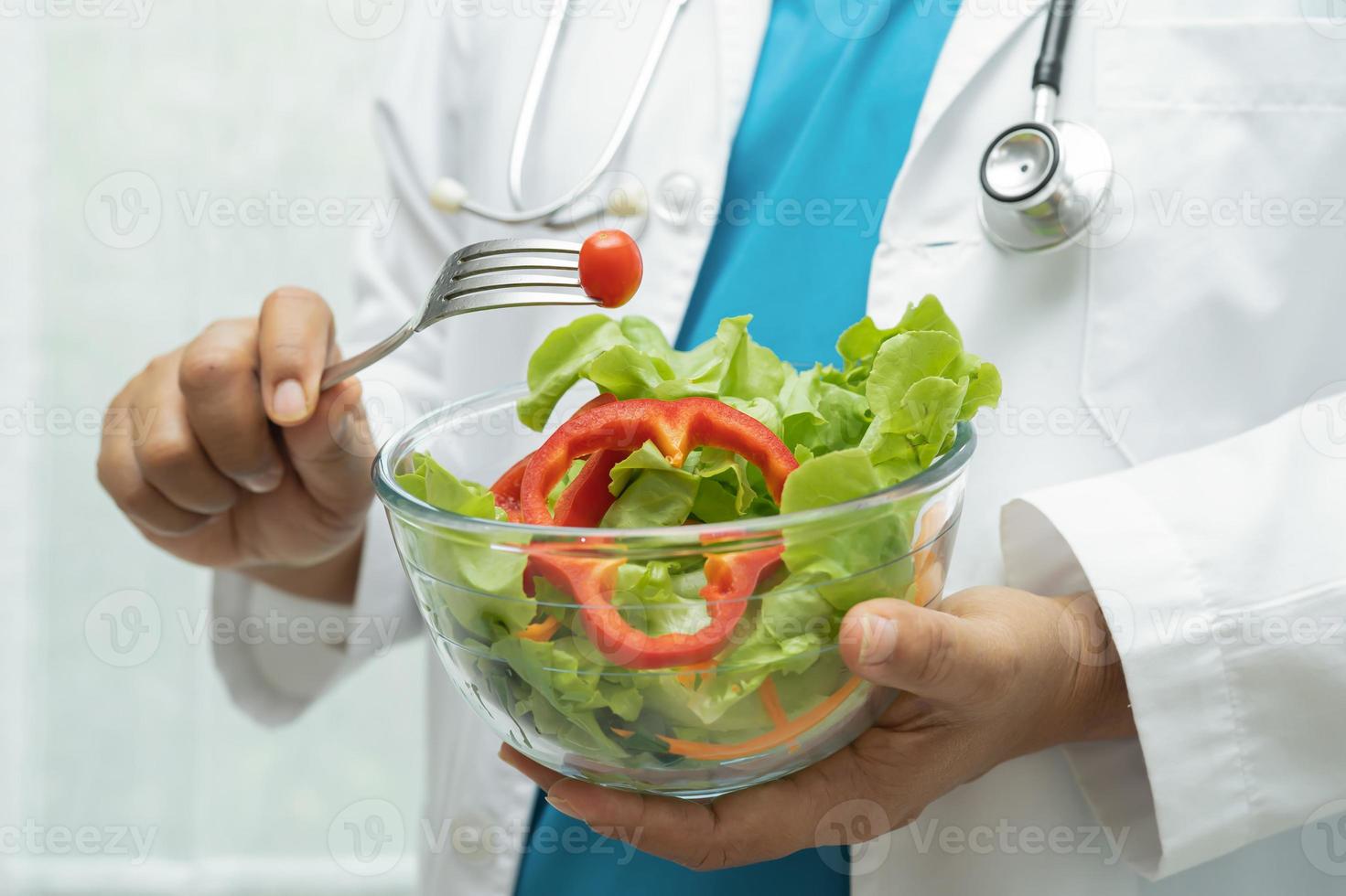 Nutritionist doctor holding healthy vegetable vitamin food for patient in hospital. photo