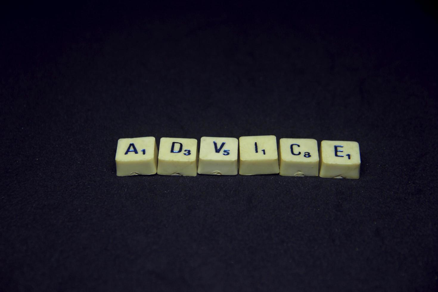 Alphabet english word with advice saying or spelling photography. Word block isolated on dark horizontal black background. Simple business image themed idea concept photo. photo