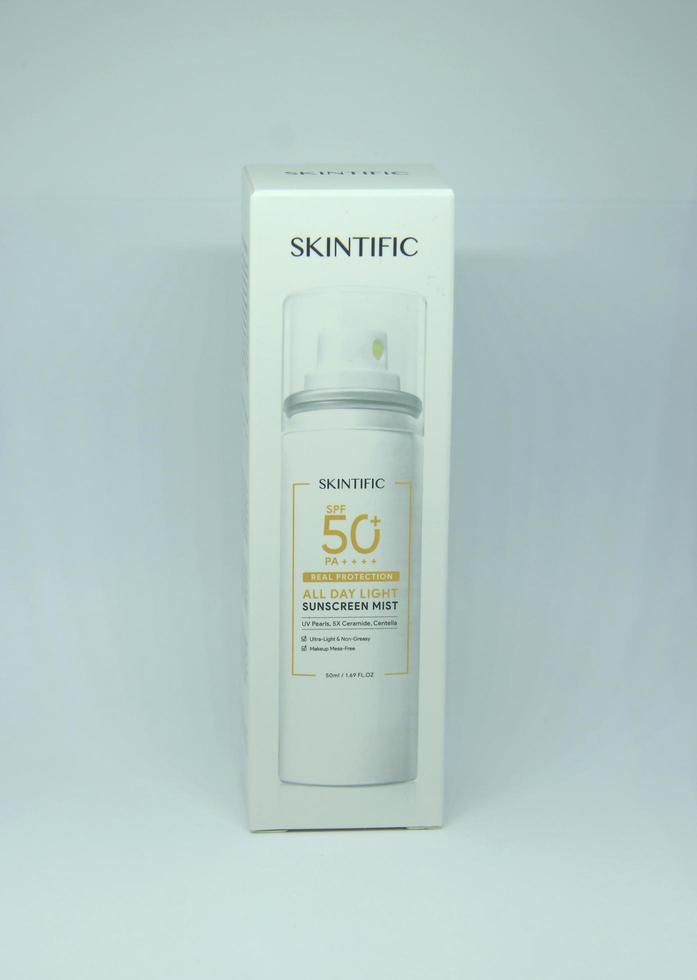 Jakarta, Indonesia - April 21th, 2023 - Skintific sun screen spray spf 50 solar uv block packaging box product object photography isolated on plain white landscape horizontal background. photo