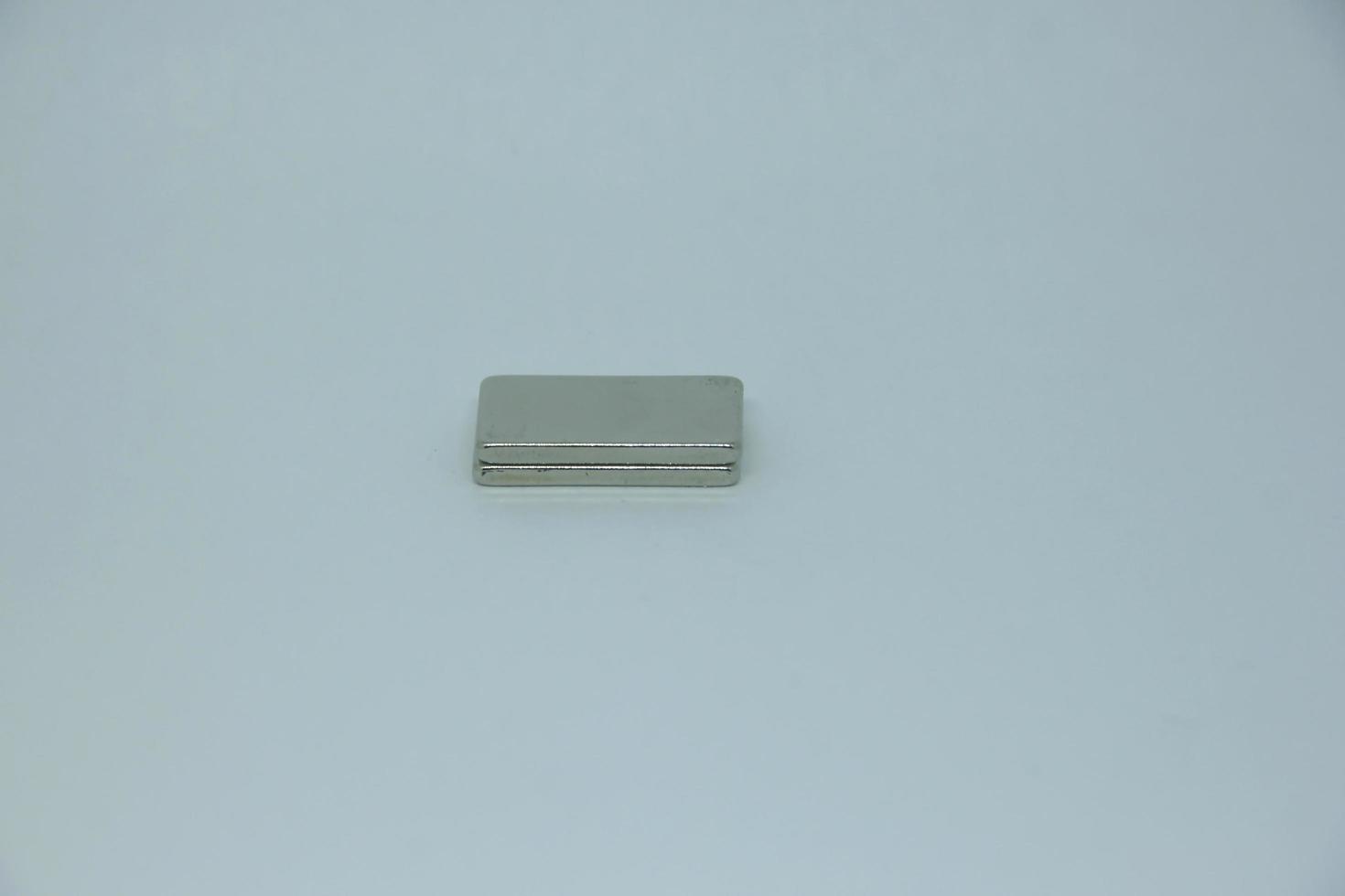 A couple of two small magnet bar with rectangle shape. Isolated object photo on white background.