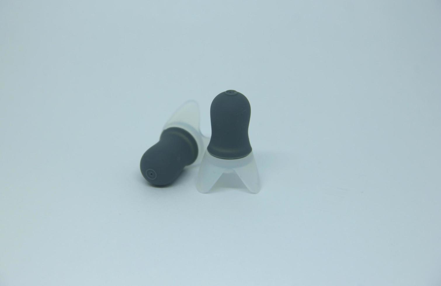 a couple of two gray ear plug without string. Object for blocking noises isolated photo on white background.