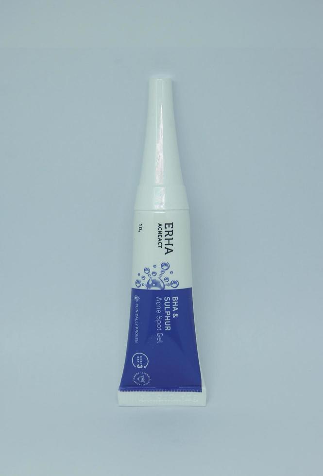 Jakarta, Indonesia - April 21th, 2023 - Erha acne or blemish gel product treatment with white packaging tube. Product object photography isolated on plain white landscape horizontal background. photo