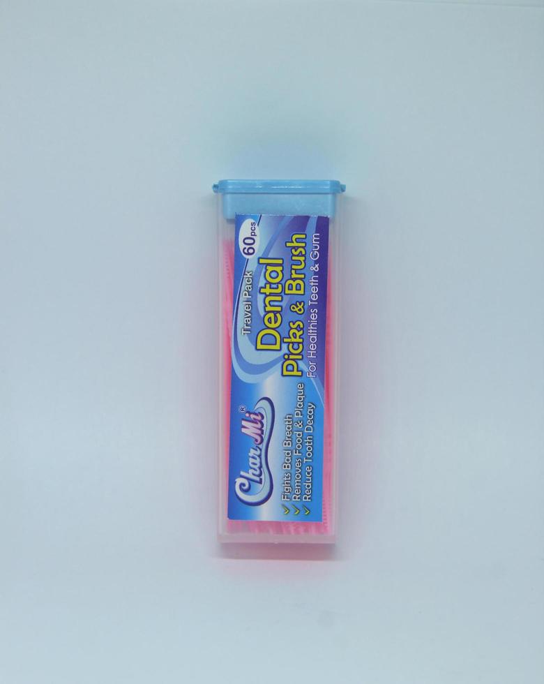 Jakarta, Indonesia - April 21th, 2023 - Char mi pink dental tooth pick and brush product object photography isolated on plain white landscape horizontal background. photo