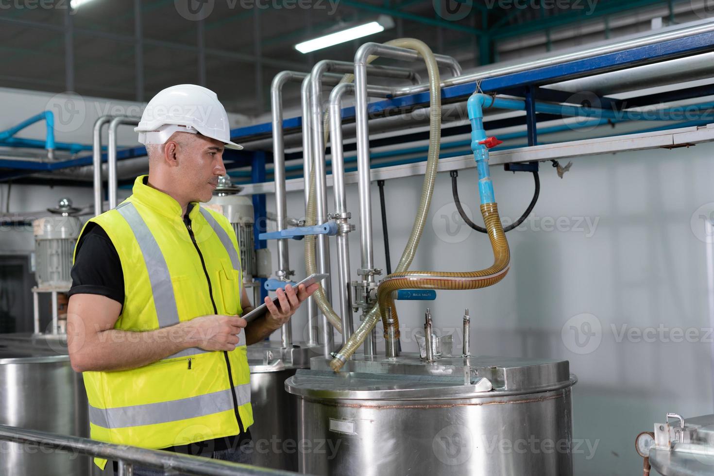 Engineers or factory managers wearing safety helmet inspect the machines in the production line. Utility inspector check machine and test the system to meet the standard. machine, maintenance. photo