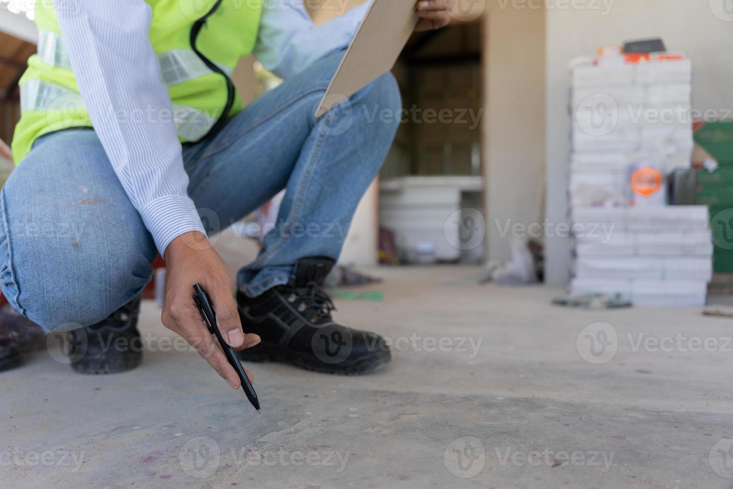 inspector or engineer is inspecting construction and quality assurance new house using a checklist. Engineers or architects or contactor work to build the house before handing it over to the homeowner photo