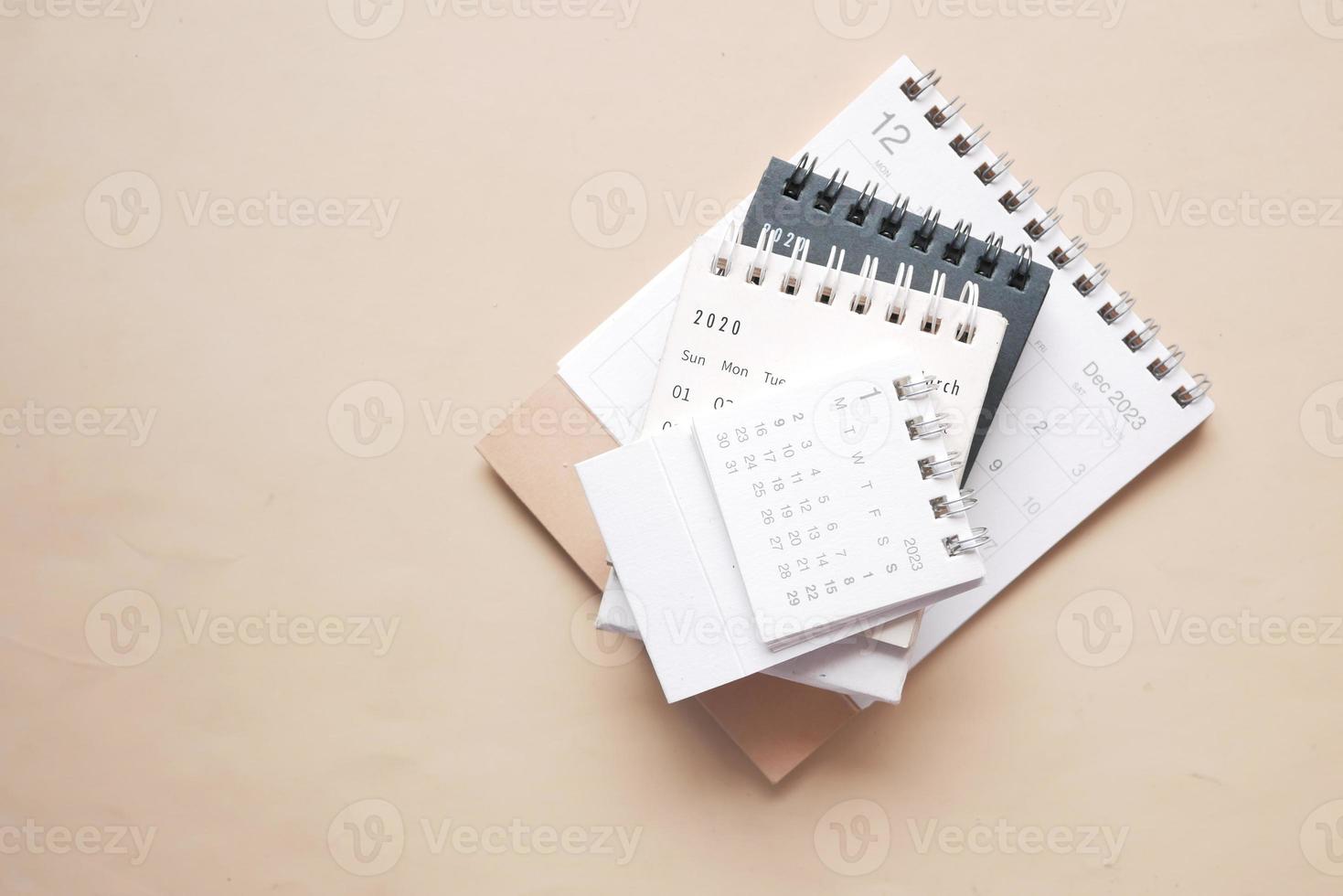 tack of calendar and cup of tea on table photo