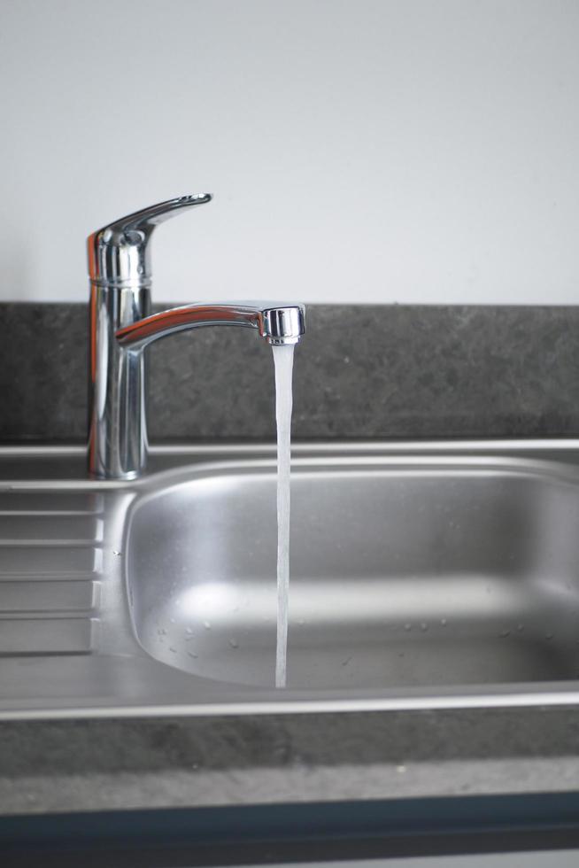 water pouring from a faucet tap slow motion photo