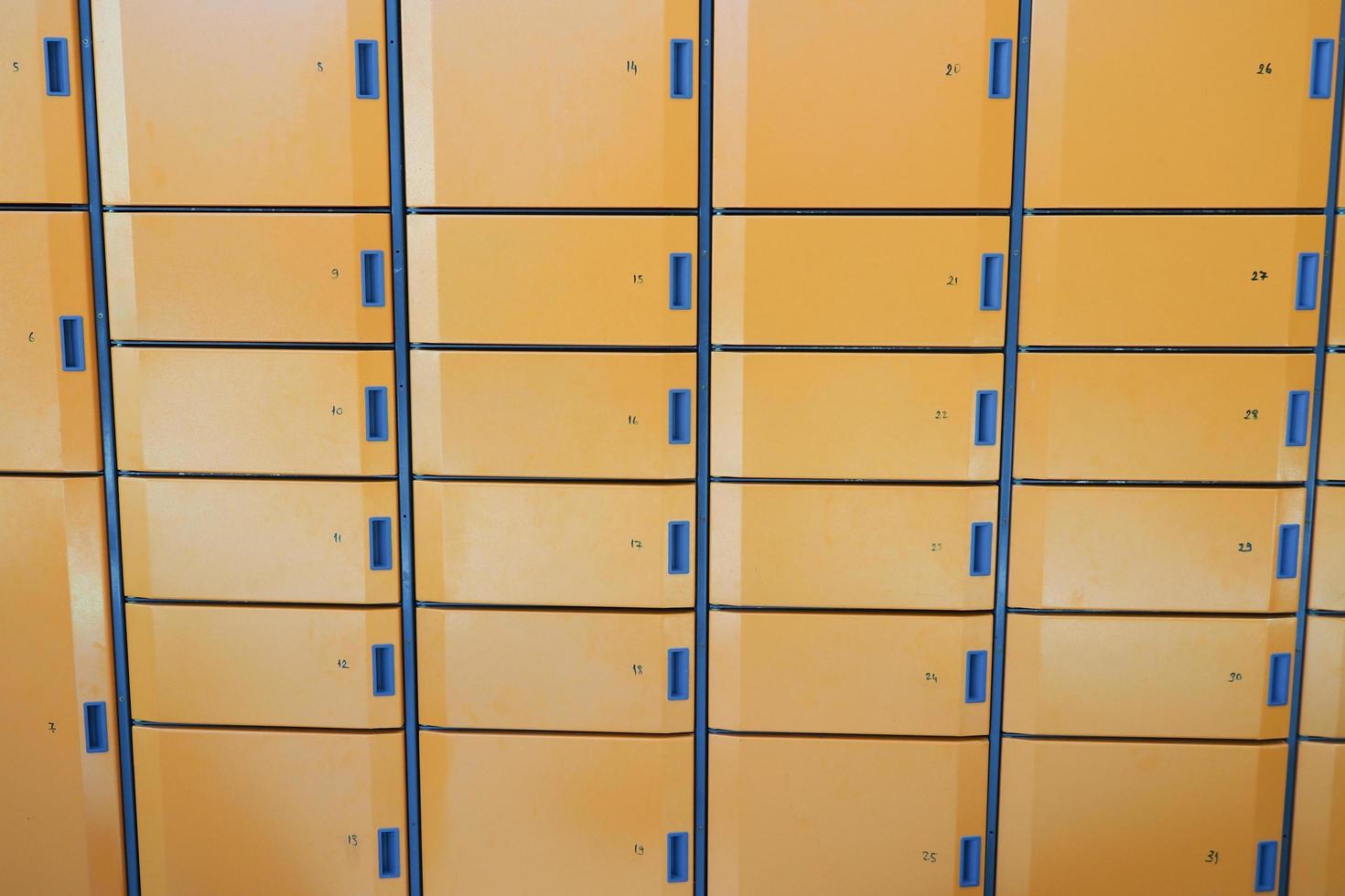 orange color storage box in public place. safe storage locker for shopping malls photo