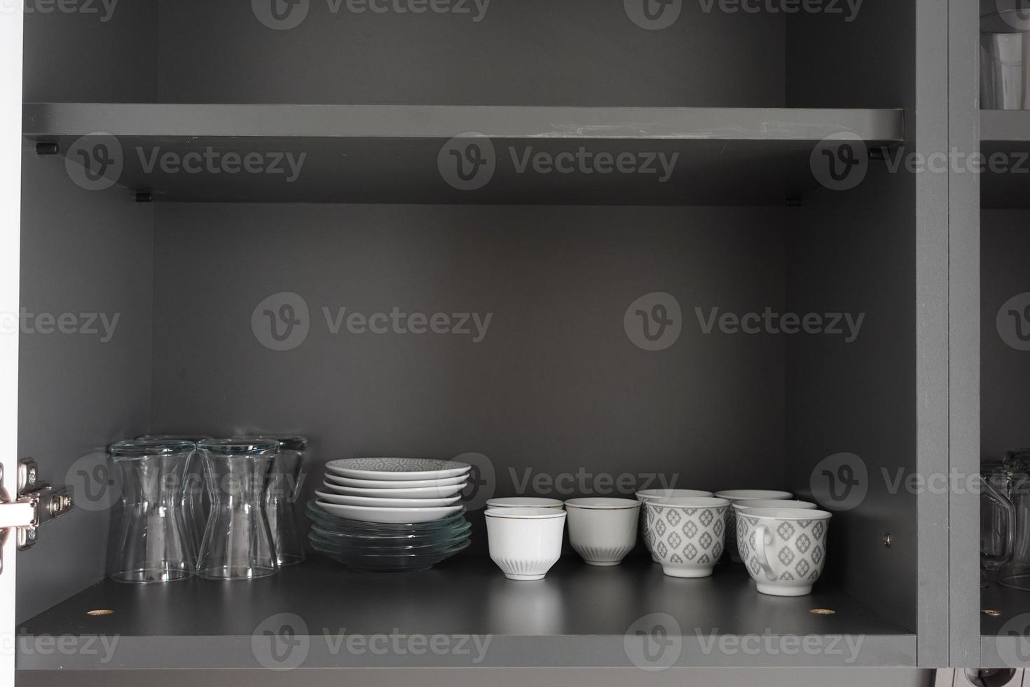 White Dishes and Bowls in Kitchen Cabinet. photo