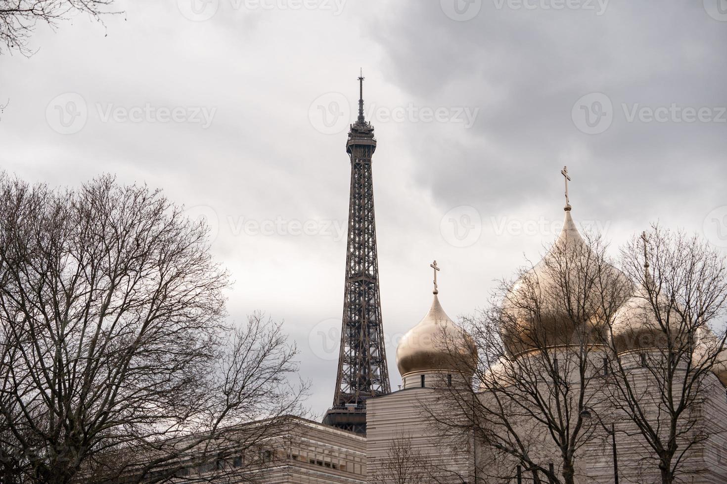 Close up view of The Eiffel Tower head  with golden dome mosque. photo