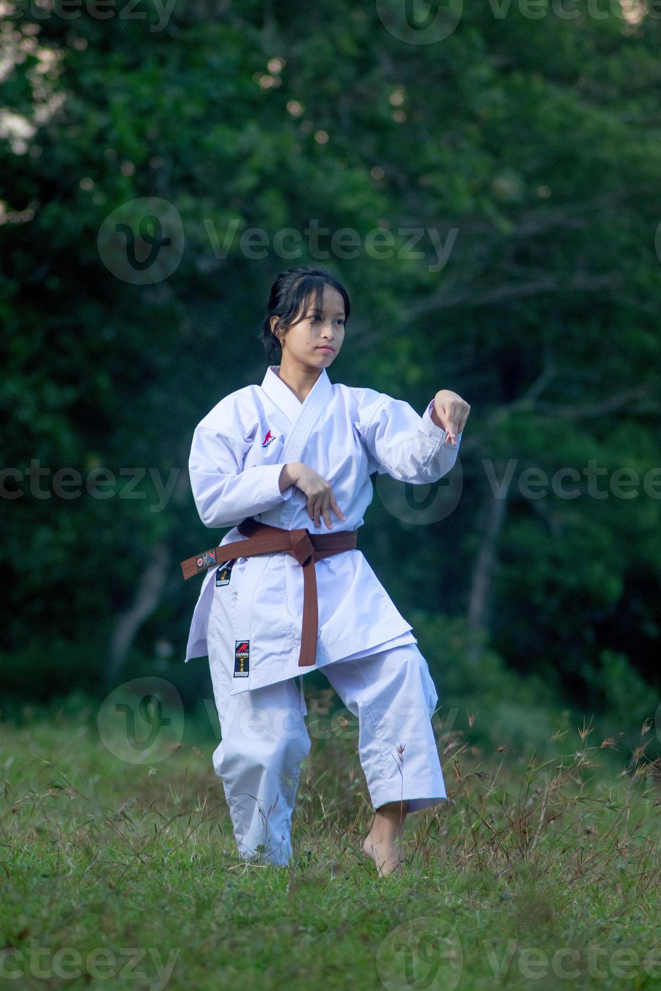 Photo of female karate person in action pose outdoor. Martial art woman