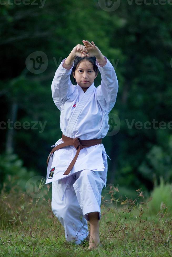 Photo of female karate person in action pose outdoor. Martial art woman
