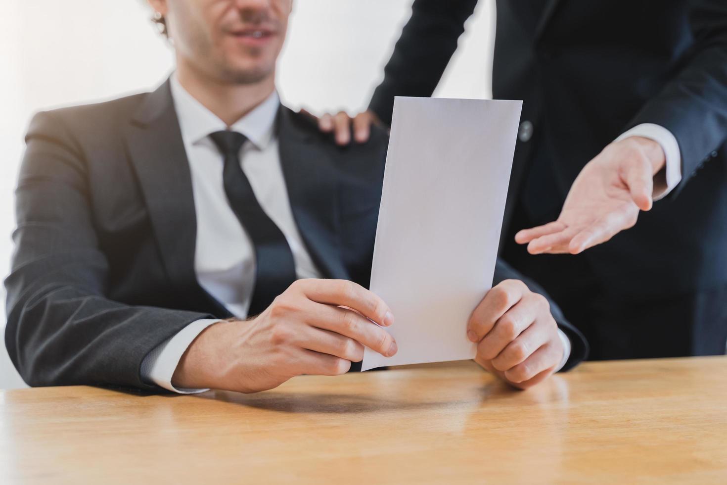 Good job asian manager man giving financial reward in an envelope, business letter extra salary to company employee, caucasian male worker office hand received premium bonus, getting cheque from boss. photo