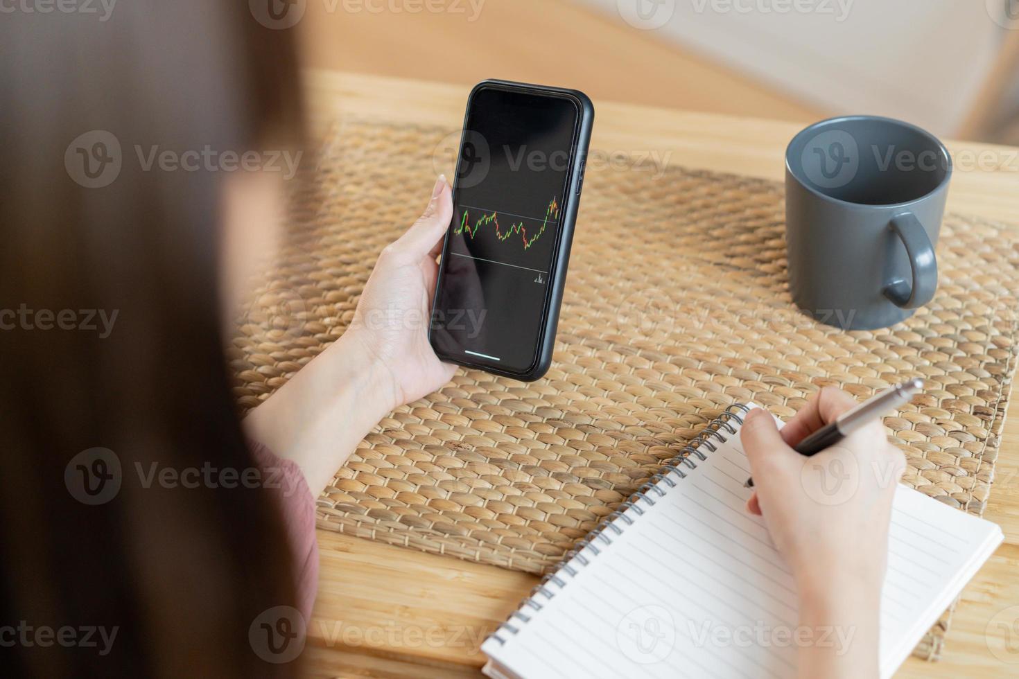 Investor analyzing exchange market, asian young business woman, girl trader on graphic charts on tablet, smartphone for trading stock, looking at screen with diagrams at home office. Start up people. photo