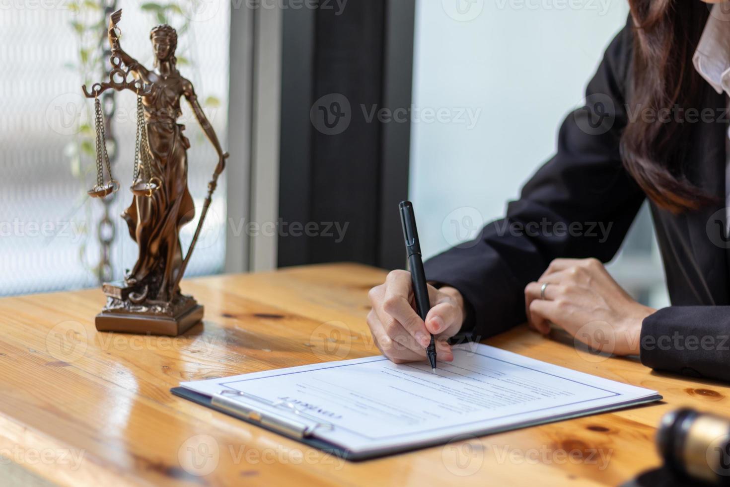 Lawyer holding contract documents in hand and preparing to sign a consulting contract for a team of business people who need legal advice to run their business in accordance with the law photo