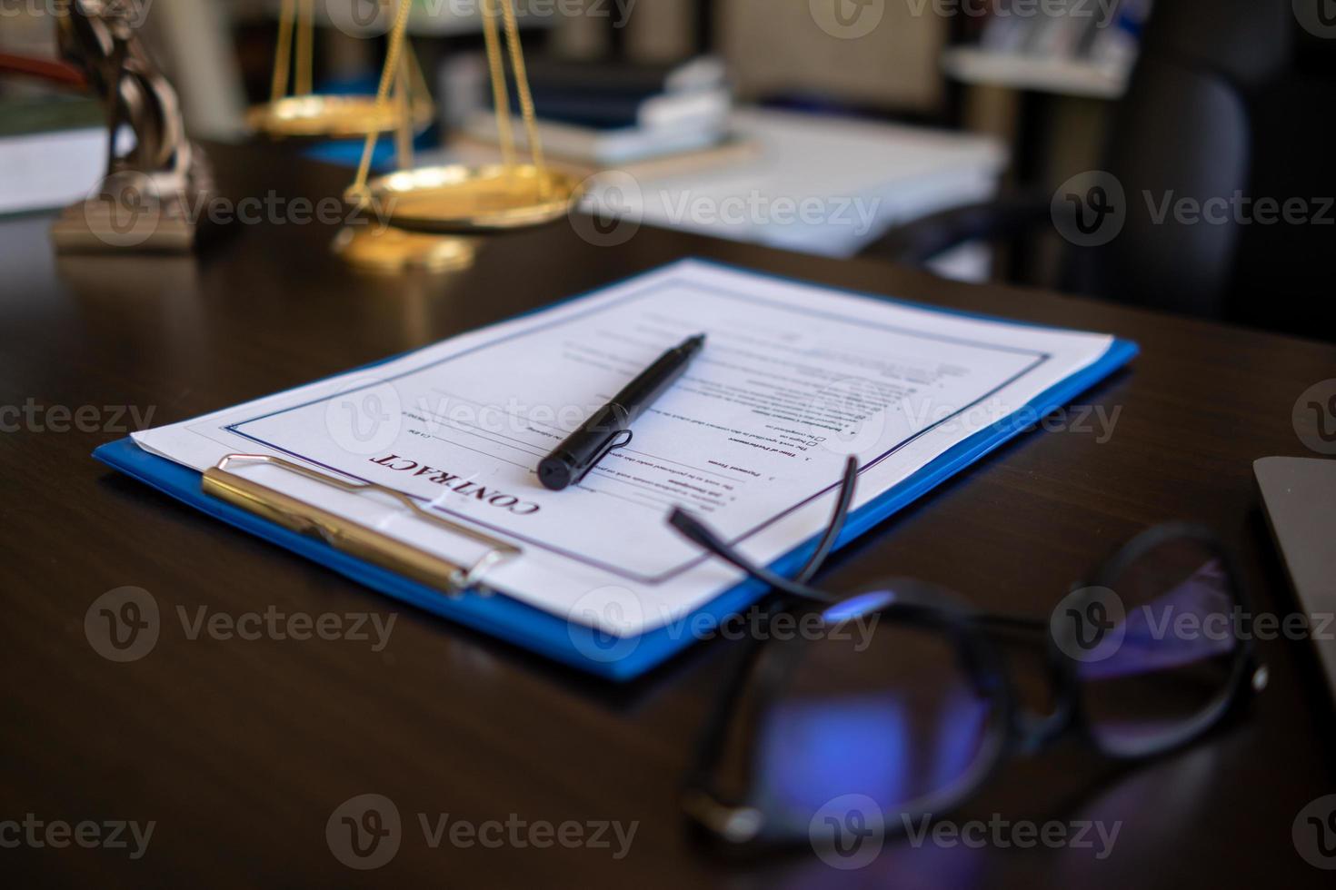 Lawyer holding contract documents in hand and preparing to sign a consulting contract for a team of business people who need legal advice to run their business in accordance with the law photo