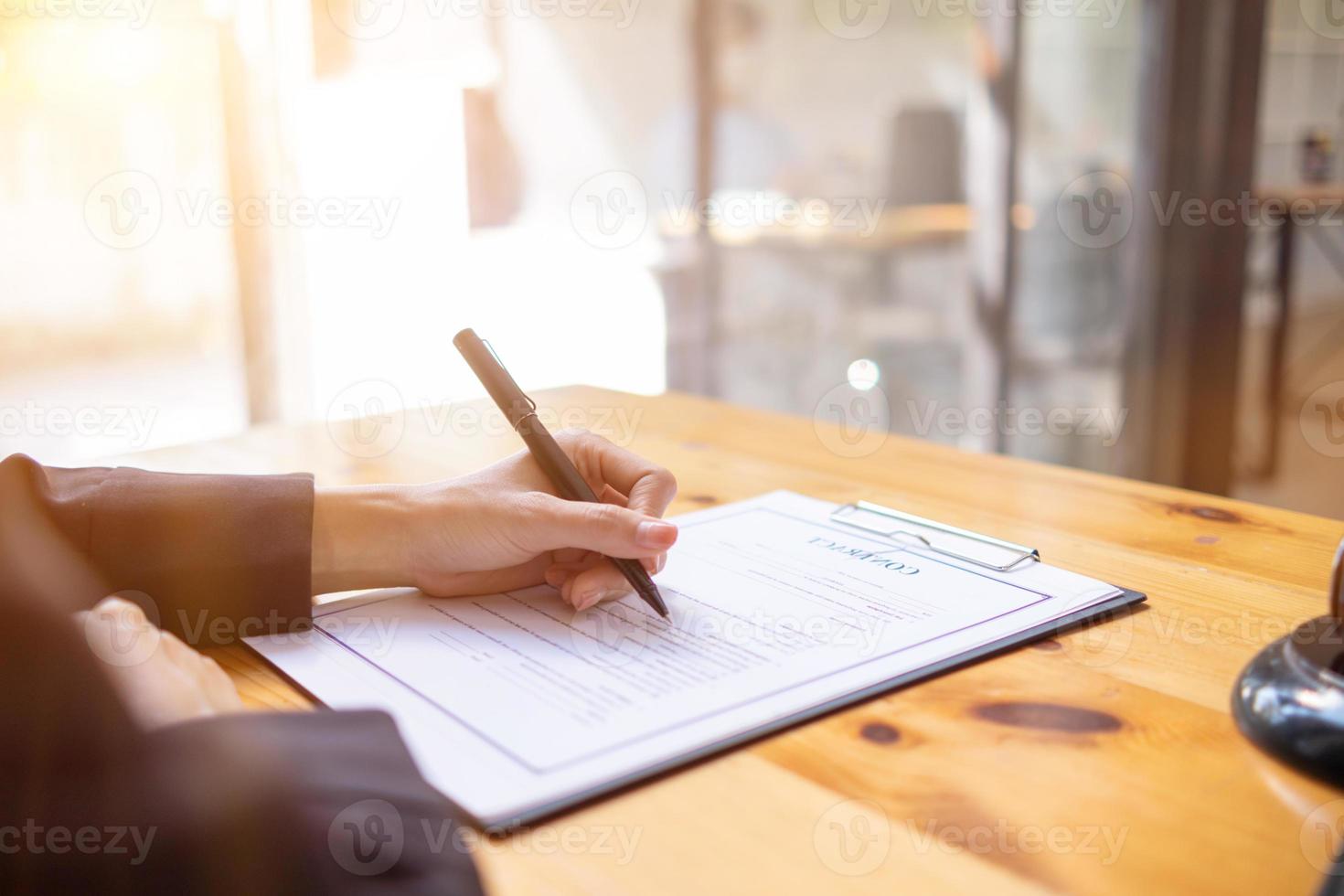 Lawyer holding contract documents in hand and preparing to sign a consulting contract for a team of business people who need legal advice to run their business in accordance with the law photo