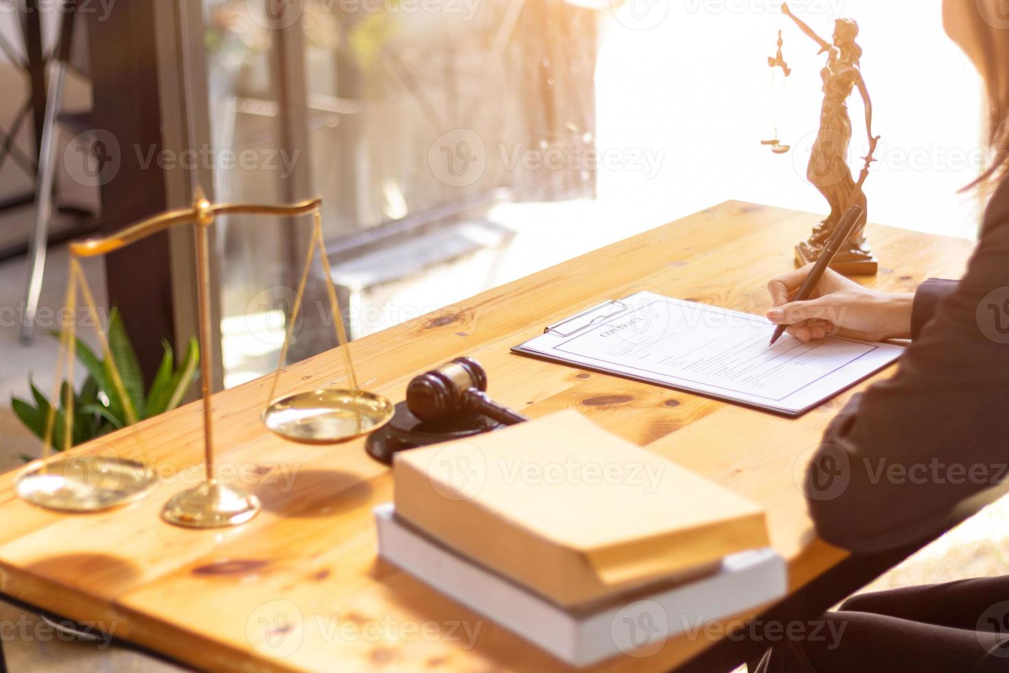 Lawyer holding contract documents in hand and preparing to sign a consulting contract for a team of business people who need legal advice to run their business in accordance with the law photo