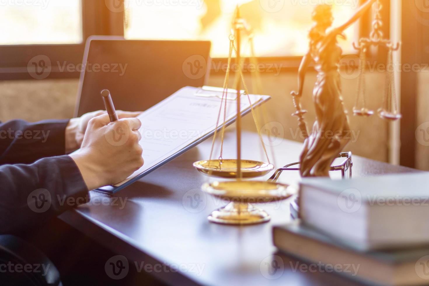 Lawyer holding contract documents in hand and preparing to sign a consulting contract for a team of business people who need legal advice to run their business in accordance with the law photo